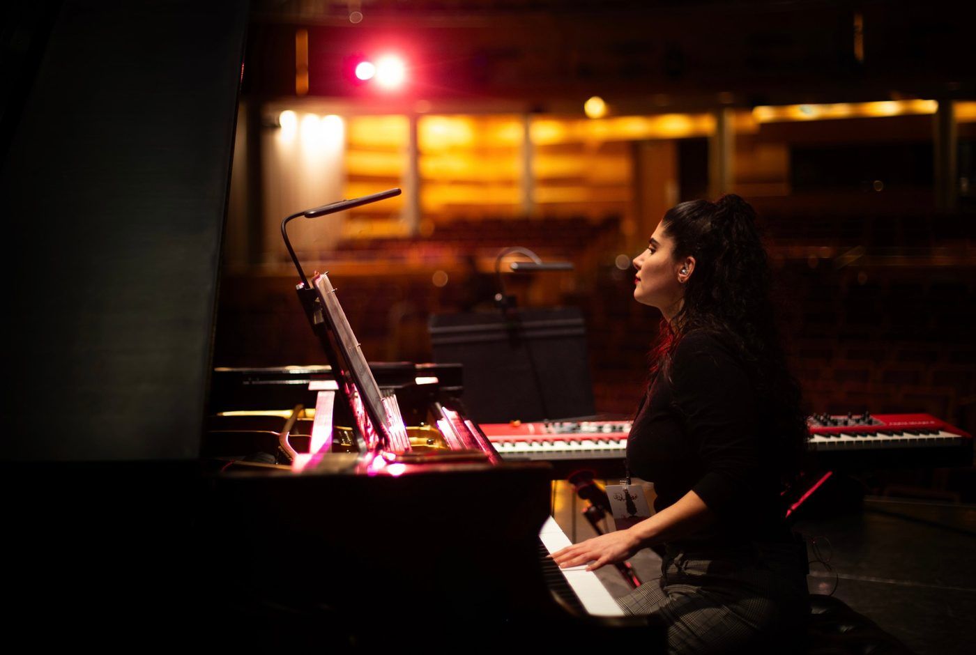 Homa Samiei at the piano on a theatre stage