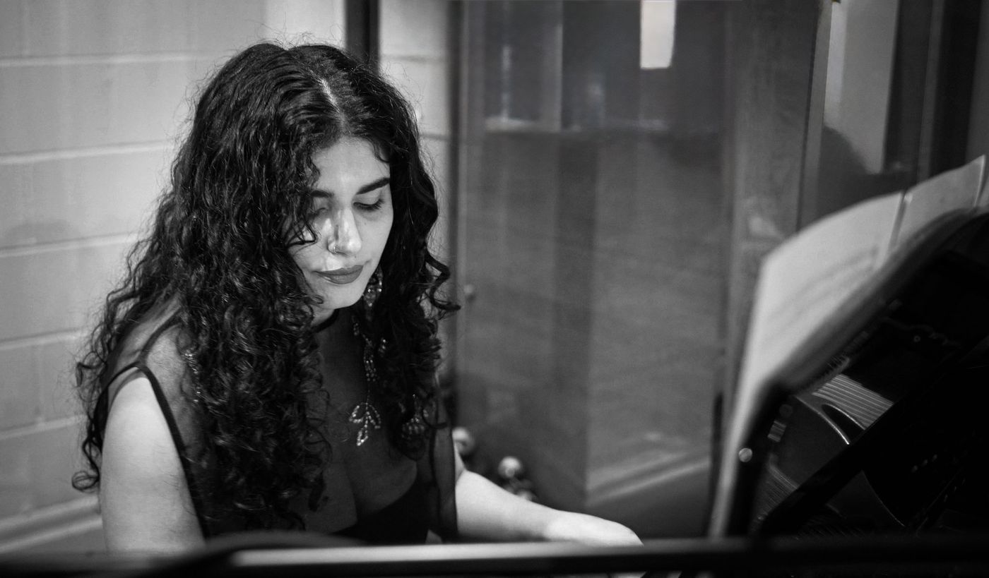 Homa Samiei playing piano, black and white